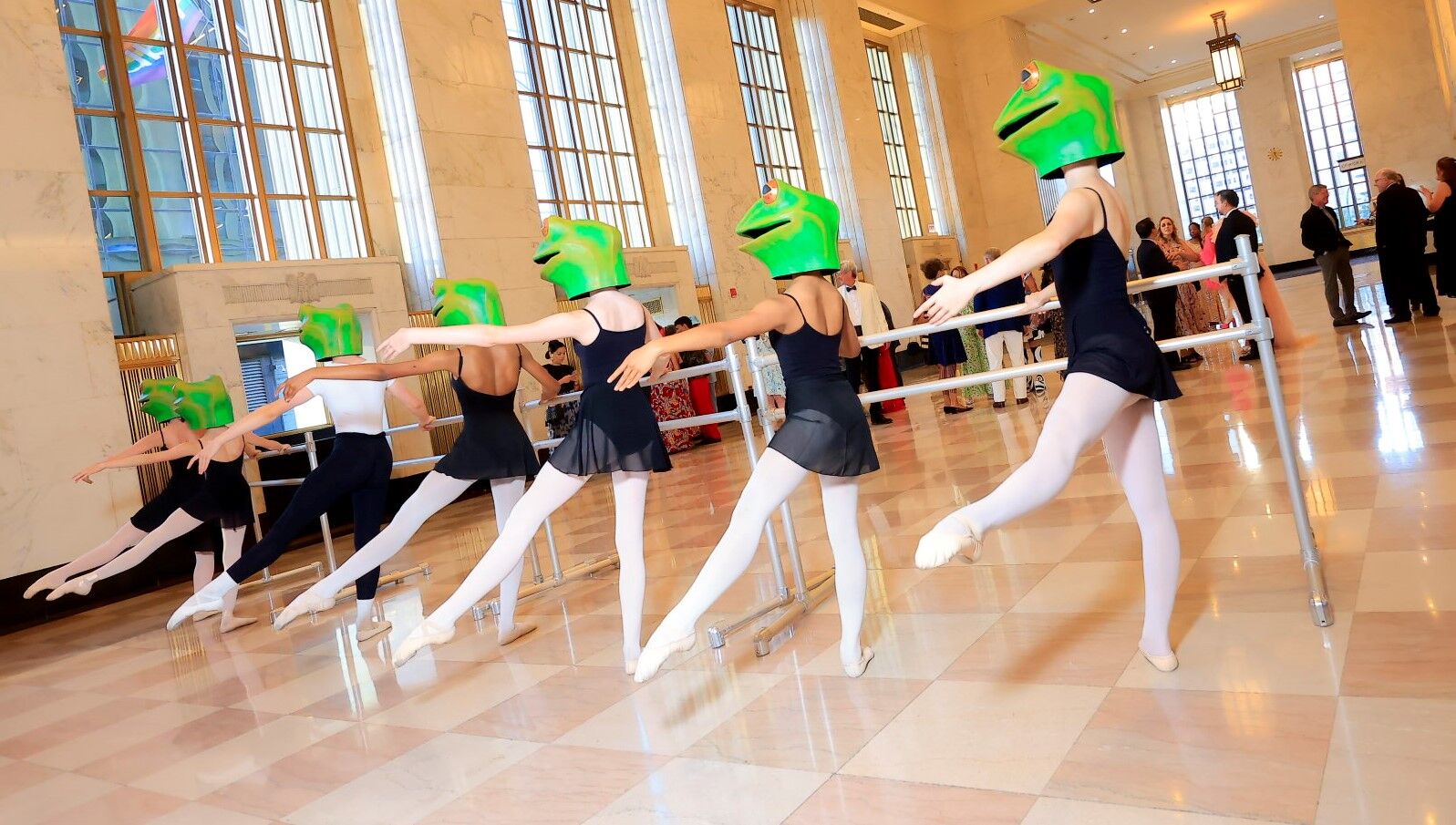 Dancers were seen 'warming up' in frog heads as guests filed in. (Sean Su photo)
